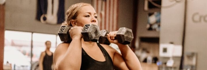 Woman using dumbbells at CrossFit in Greeley