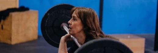 Woman 55+ lifting weights